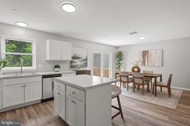a kitchen with white cabinets and sink
