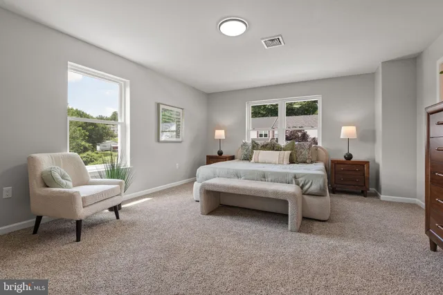 a bedroom with a bed and a couch