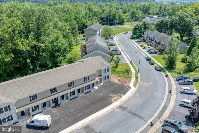 an aerial view of a house with a garden and trees
