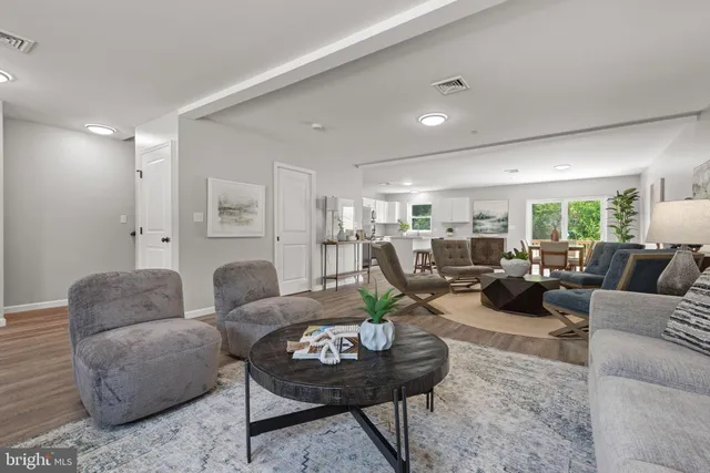 an empty room with wooden floor and closet area