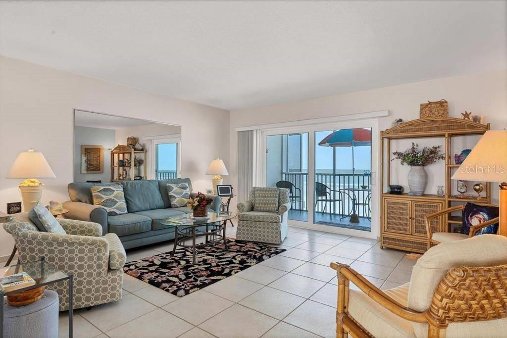 6154 Midnight Pass Road, Unit 305 Sarasota, FL 34242 - Photo 2 of 12 a living room with furniture and a window