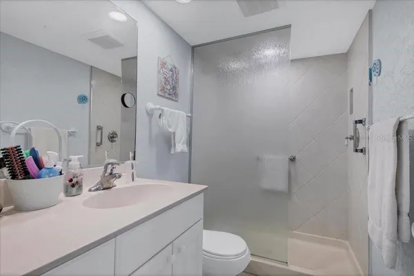 a bathroom with a sink toilet and shower