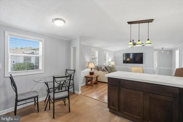 a room with a chandelier furniture and a flat screen tv