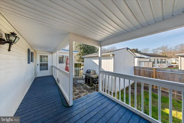 a front view of a house with a bench