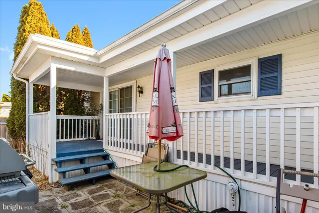 a view of house with a small yard and wooden fence