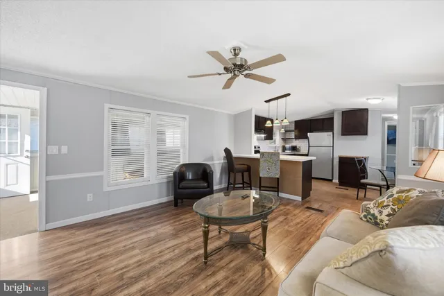 a living room with furniture a fireplace and a window