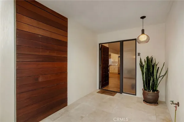 a view of empty room with potted plants