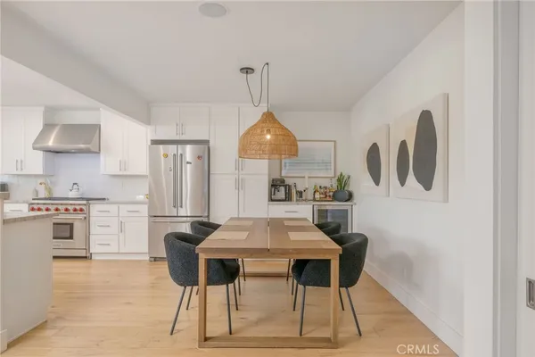 a dining room with furniture and kitchen view
