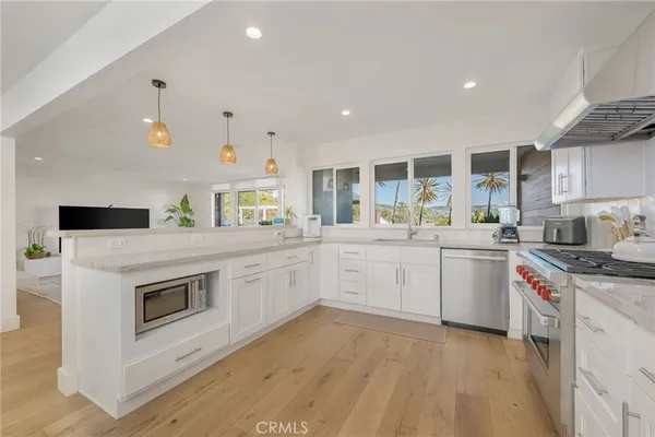 a kitchen with a sink stove and microwave
