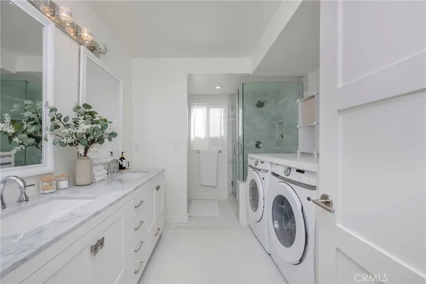 a bathroom with a granite countertop sink mirror and vanity