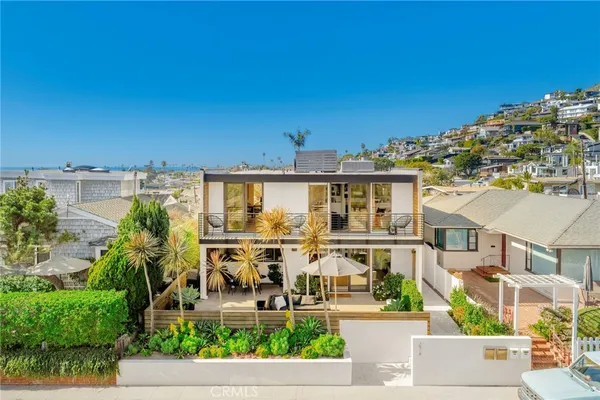 an aerial view of a house with garden space and sitting area