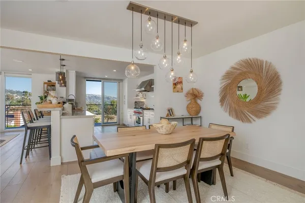 a dining room with furniture and wooden floor