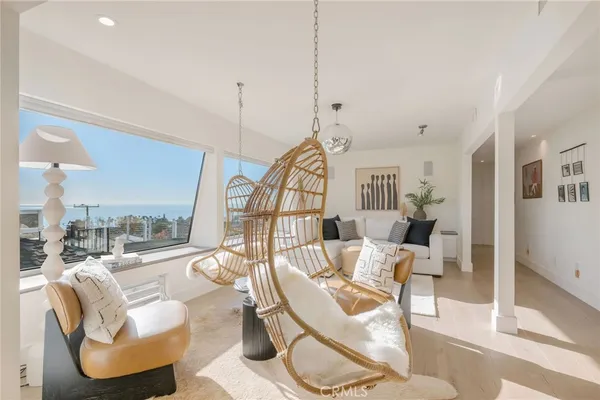 a living room with furniture a ceiling fan and a wooden floor