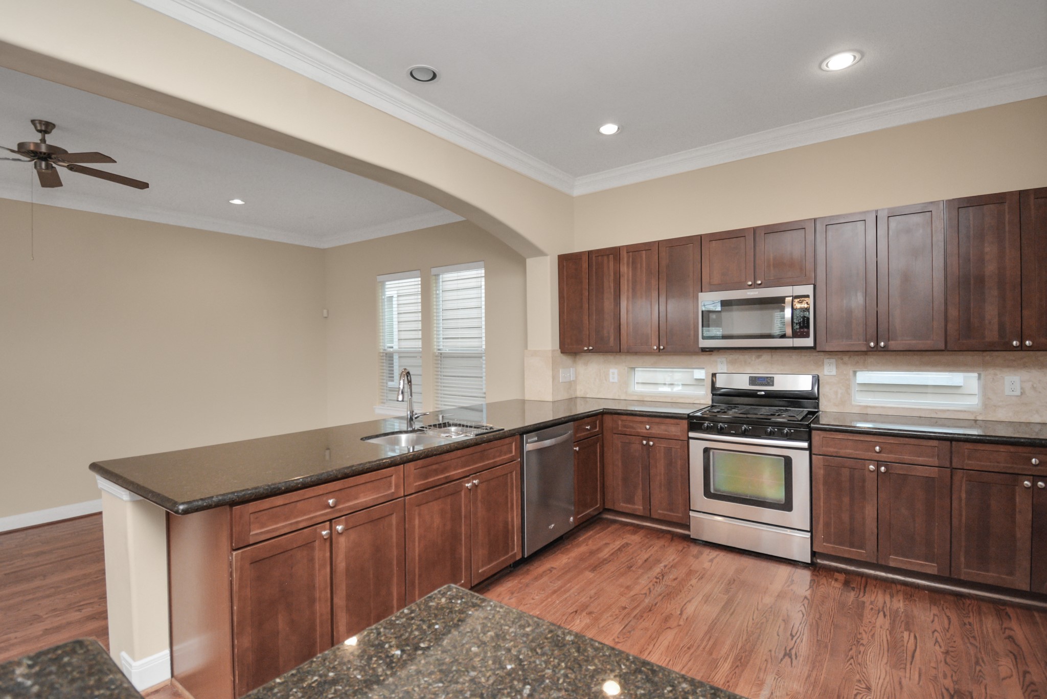 1137 West 24th Street, Unit A Houston, TX 77008 - Photo 11 of 40 a kitchen with sink a stove and cabinets