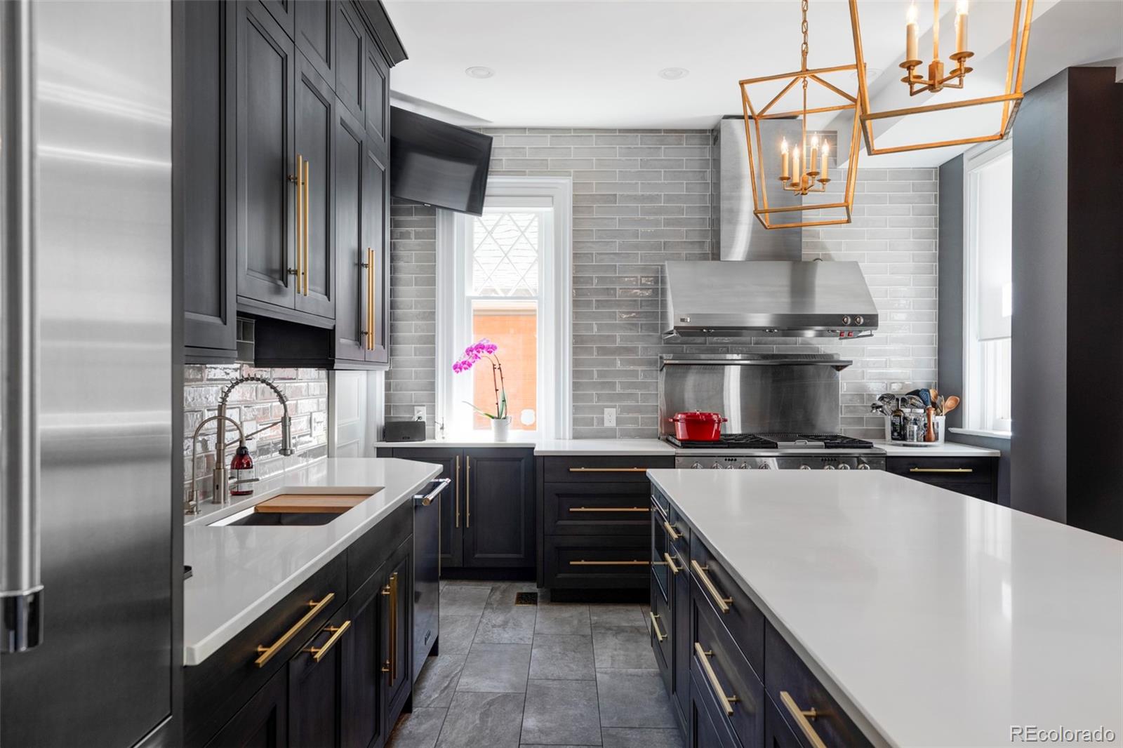 1275 Franklin Street Denver, CO 80218 - Photo 12 of 48 a kitchen with stainless steel appliances a sink stove and refrigerator