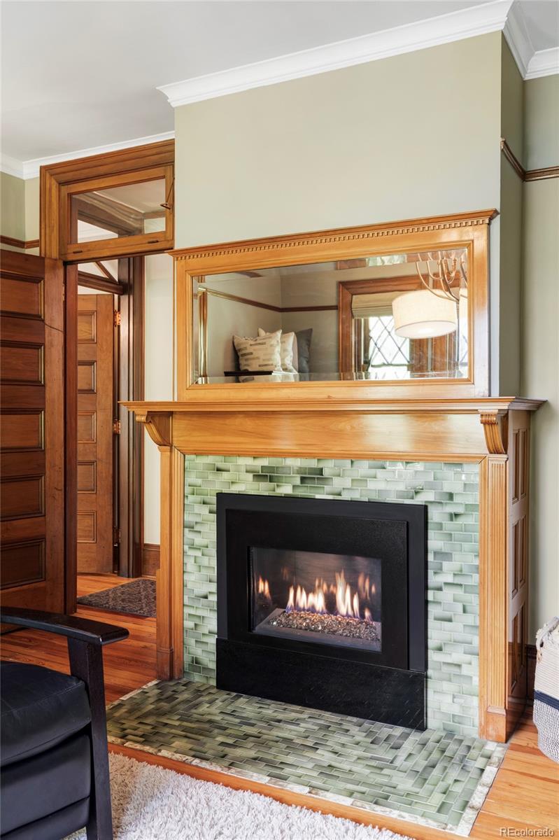 1275 Franklin Street Denver, CO 80218 - Photo 23 of 48 a fireplace with a clock on top of it