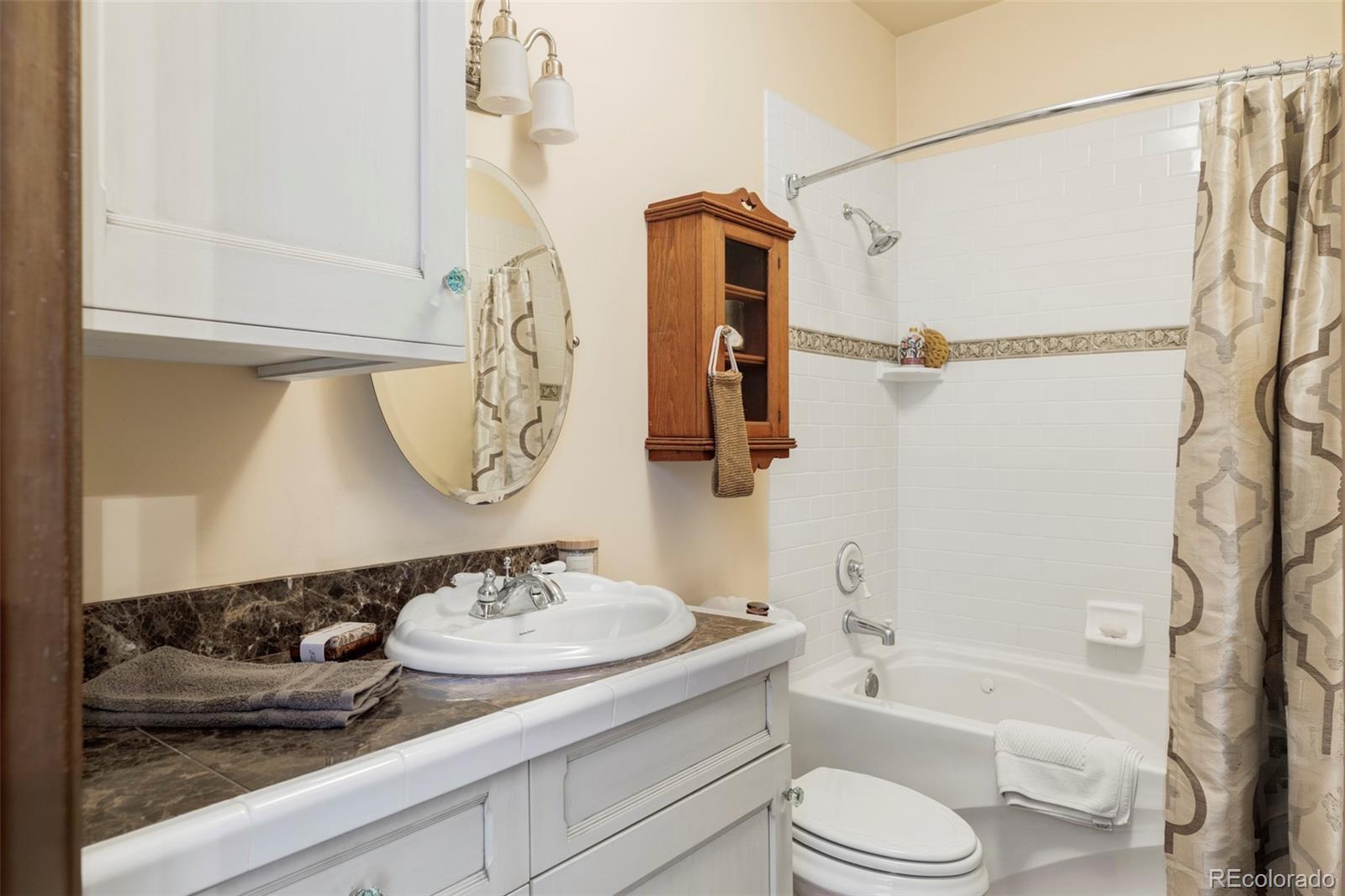 1275 Franklin Street Denver, CO 80218 - Photo 25 of 48 a bathroom with a granite countertop sink toilet and shower
