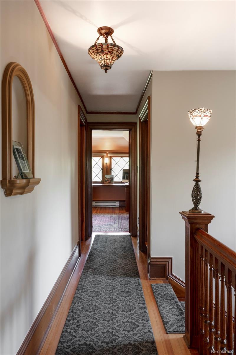 1275 Franklin Street Denver, CO 80218 - Photo 27 of 48 a view of entryway with a rug wooden floor and a chandelier