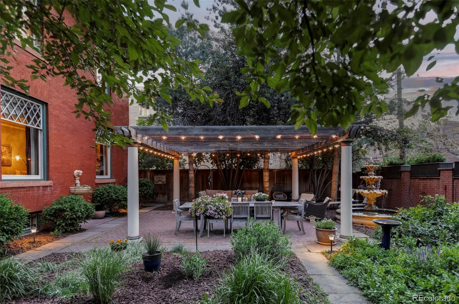1275 Franklin Street Denver, CO 80218 - Photo 40 of 48 a view of a patio with table and chairs potted plants and large tree