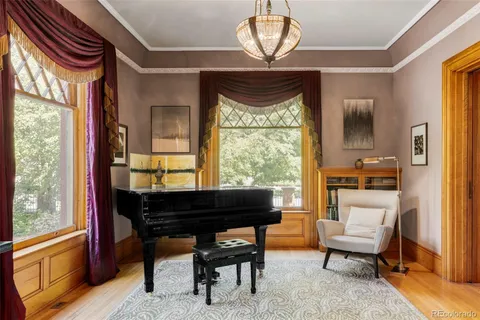 a living room with furniture a fireplace and a chandelier