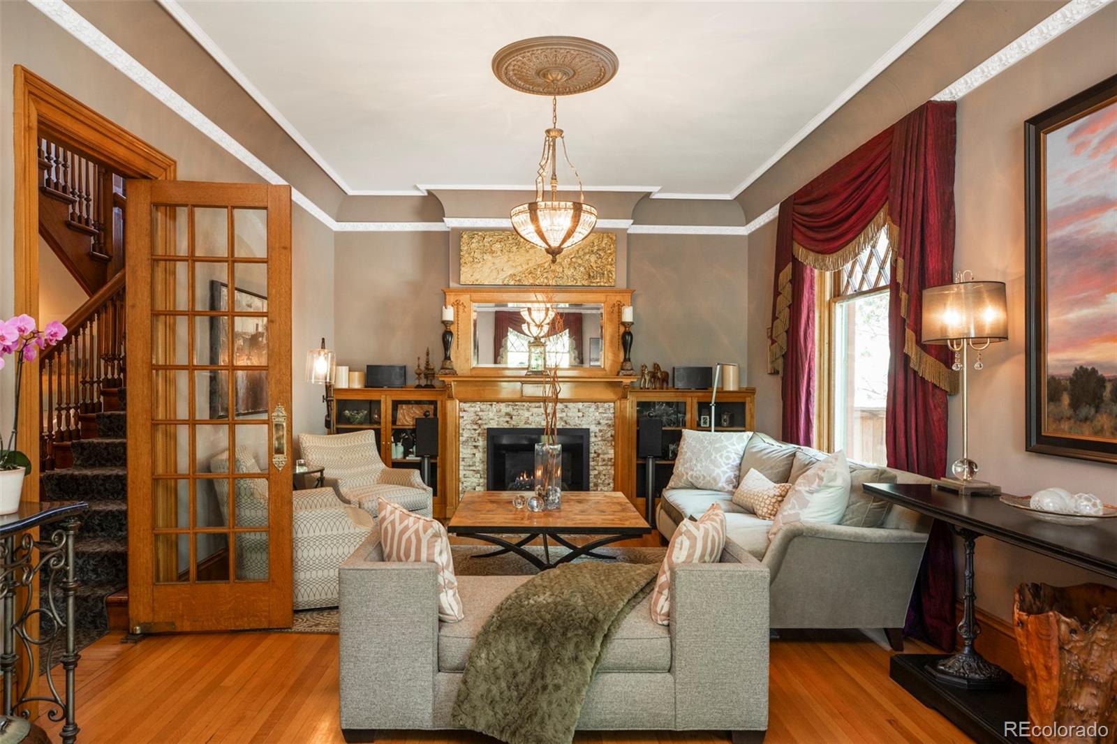 1275 Franklin Street Denver, CO 80218 - Photo 8 of 48 a living room with furniture a fireplace and a chandelier