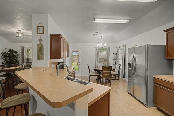 a kitchen with appliances cabinets and furniture