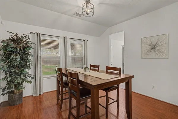 a view of a dining room with furniture window and wooden floor