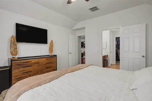 a bedroom with a bed and a flat screen tv