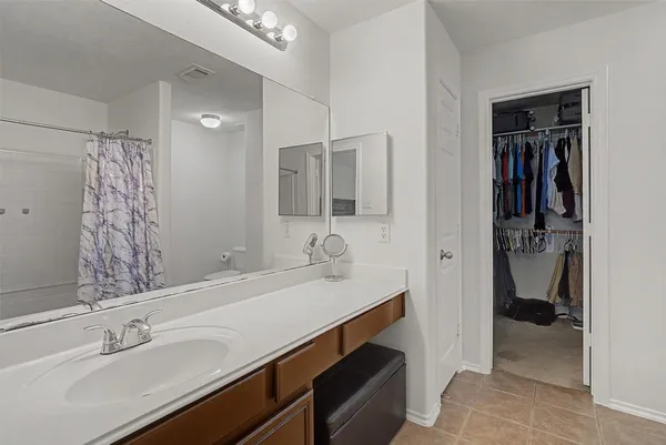a en suite bathroom with a sink and mirror