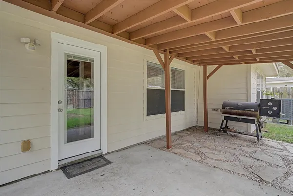 a view of a room with wooden floor and furniture