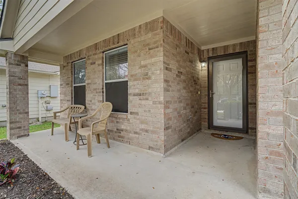 a view of a patio with table and chairs and potted plants
