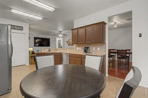 a kitchen with sink a microwave and cabinets