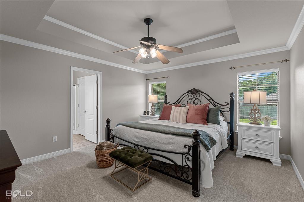 116 Augusta Avenue Benton, LA 71006 - Photo 21 of 38 a bedroom with a bed and a chandelier