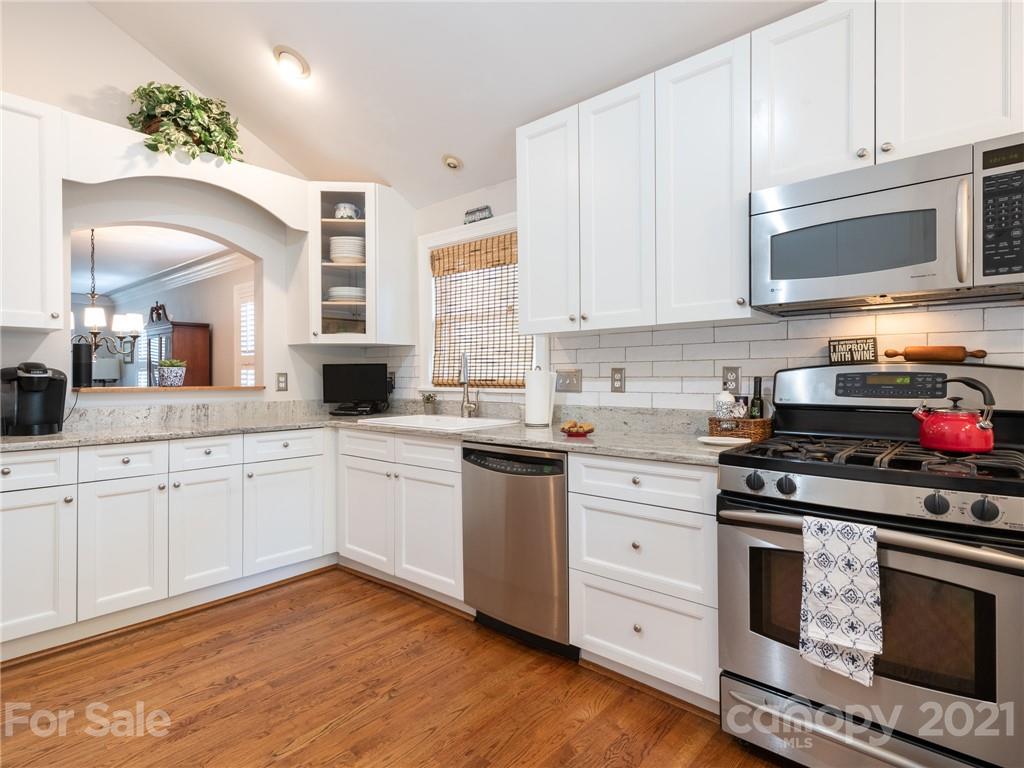 2012 Club Road Charlotte, NC 28205 - Photo 11 of 41 a kitchen with stainless steel appliances granite countertop a stove a sink and a microwave