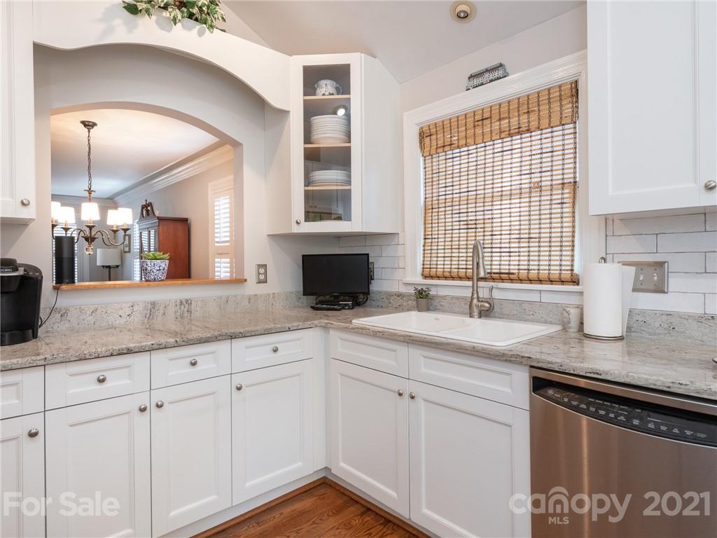 2012 Club Road Charlotte, NC 28205 - Photo 12 of 41 a kitchen with granite countertop a sink stainless steel appliances white cabinets and a window