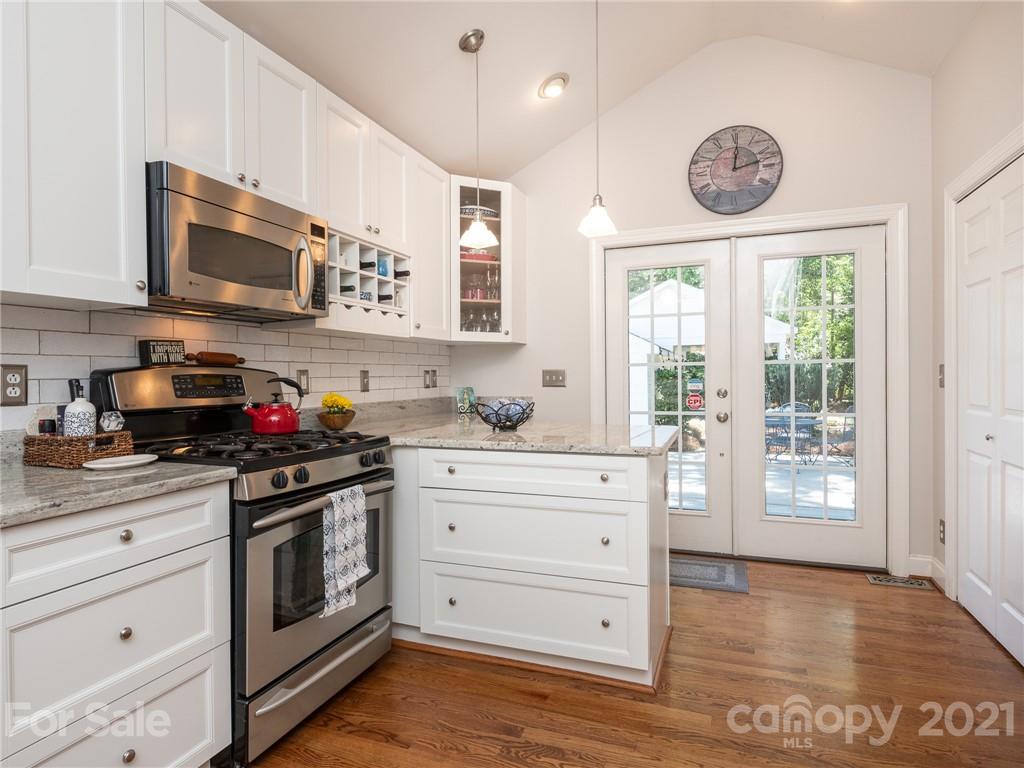 2012 Club Road Charlotte, NC 28205 - Photo 13 of 41 a kitchen with stainless steel appliances granite countertop a stove a sink and a microwave