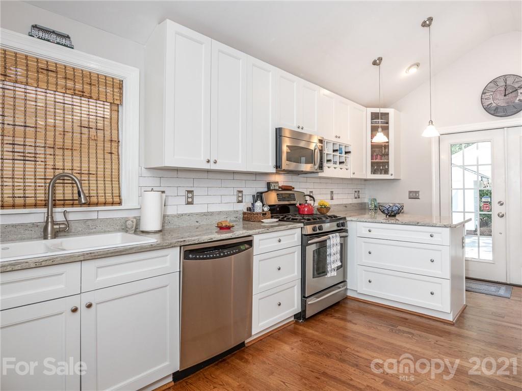 2012 Club Road Charlotte, NC 28205 - Photo 14 of 41 a kitchen with granite countertop white cabinets and white appliances