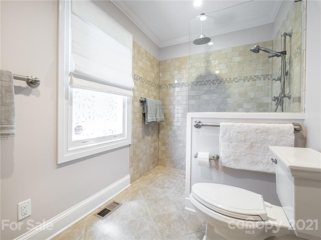 2012 Club Road Charlotte, NC 28205 - Photo 25 of 41 a bathroom with a toilet and a shower