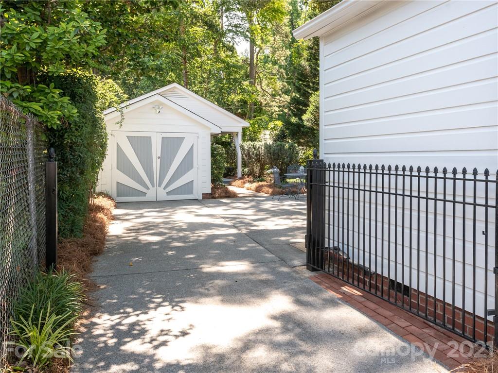 2012 Club Road Charlotte, NC 28205 - Photo 38 of 41 a view of a small yard in front of a house with wooden fence