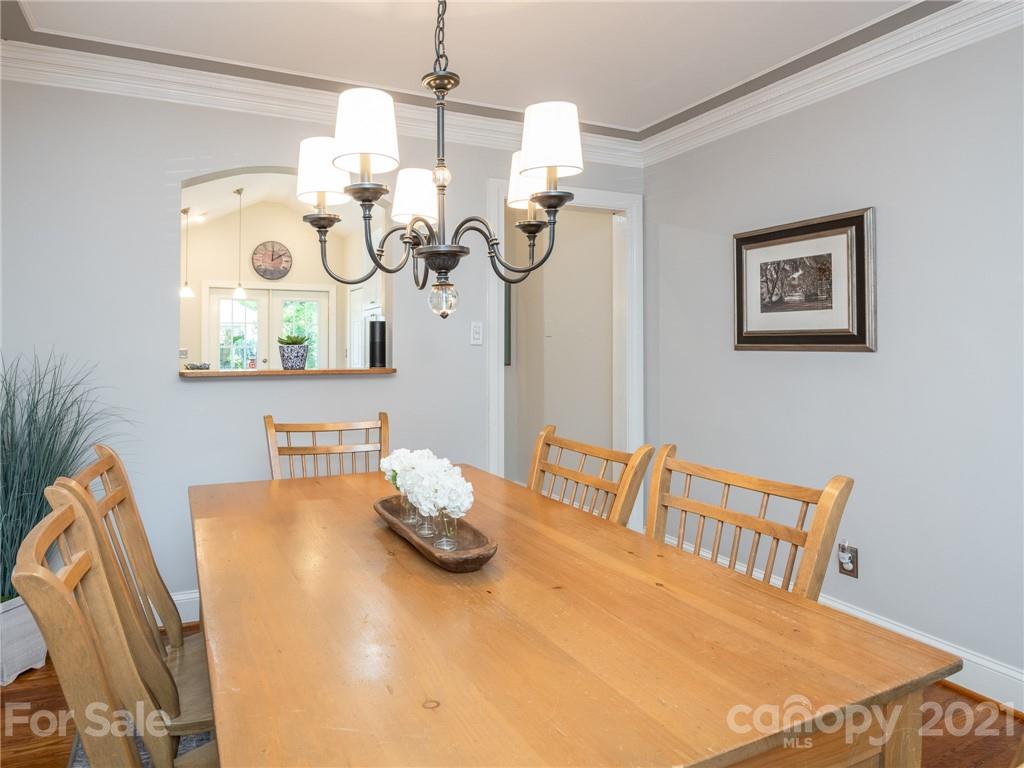 2012 Club Road Charlotte, NC 28205 - Photo 9 of 41 a view of a dining room with furniture a chandelier and wooden floor