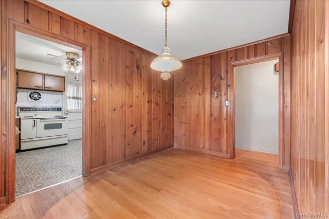a view of a room with a ceiling fan and entryway