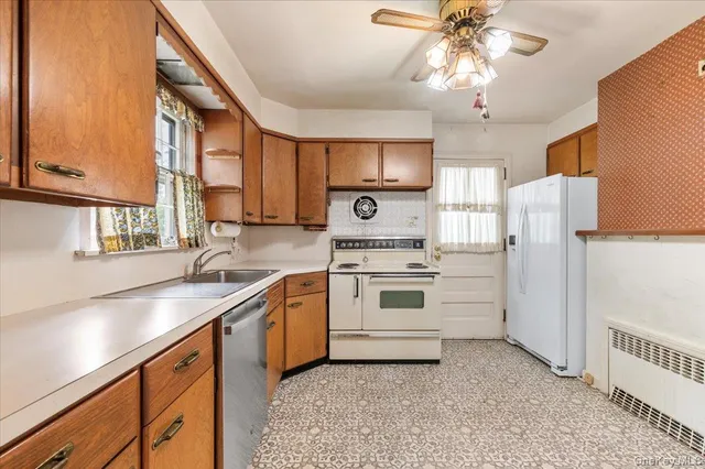 a kitchen with a sink a stove and refrigerator
