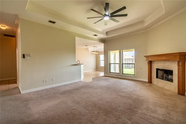 a view of a livingroom with a fireplace and a ceiling fan