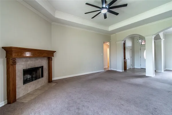 a view of empty room with fan and fireplace