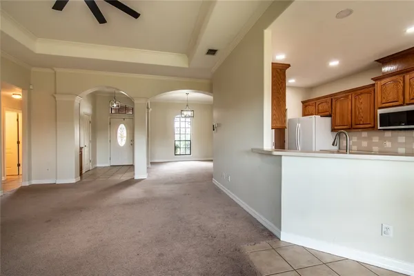 a view of a kitchen with a sink and dishwasher a refrigerator with wooden floor