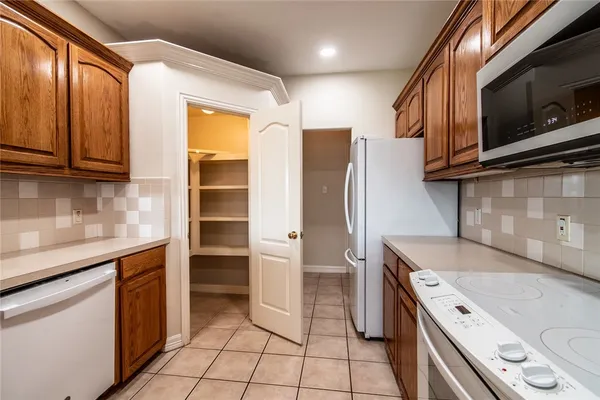 a kitchen with a sink appliances and cabinets