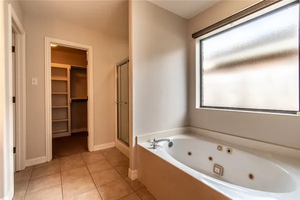 a bathroom with a bathtub and a shower
