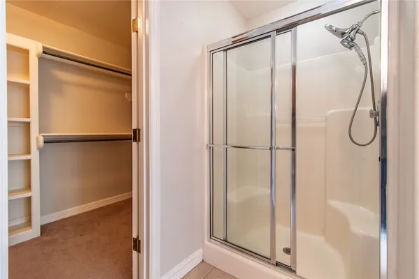 a bathroom with a glass shower door