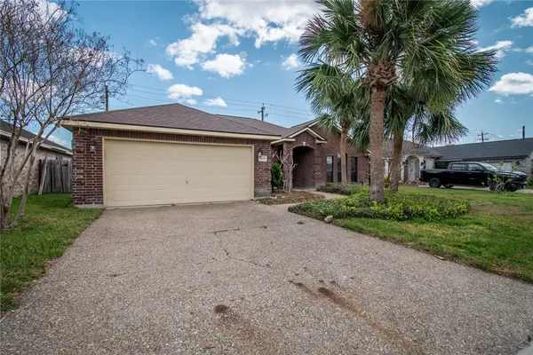 a front view of house with yard and trees