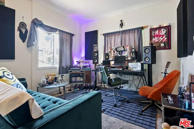 a bedroom with furniture and a flat screen tv